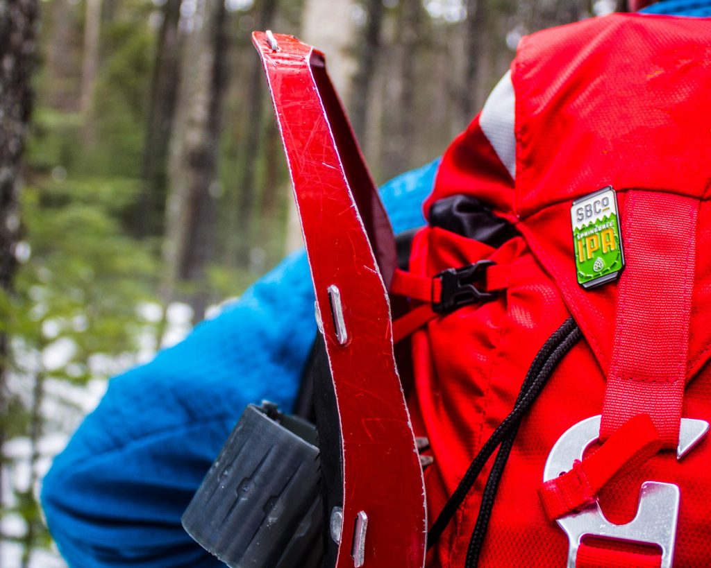 Photo of a hiker's backpack with a Springdale IPA pin on it.